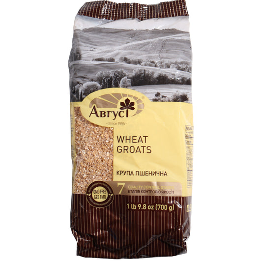 Avgust Wheat Groats, 24.69 oz (700 g) — cracked whole wheat groats with a hearty texture and nutty flavor, ideal for breakfast porridge, side dishes, soups, pilafs, and traditional Eastern European recipes. Packaged in a clear-window bag showcasing the wheat groats with Avgust branding.
