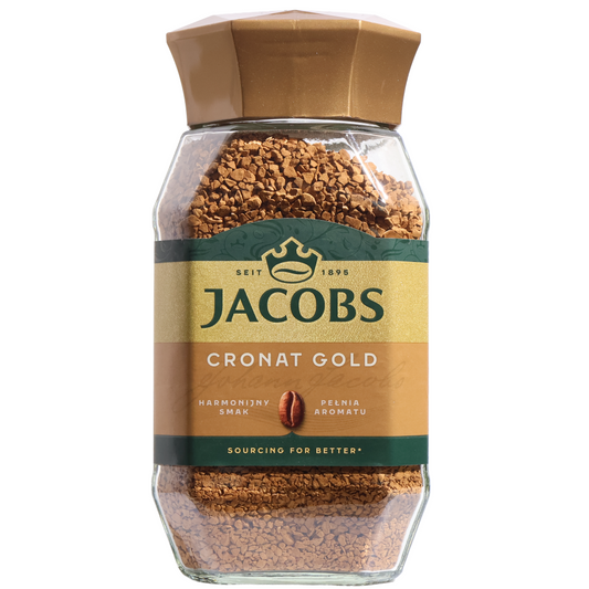 Jacobs Cronat Gold instant coffee granules in a faceted clear jar with a gold lid and gold-and-green label with a coffee bean.