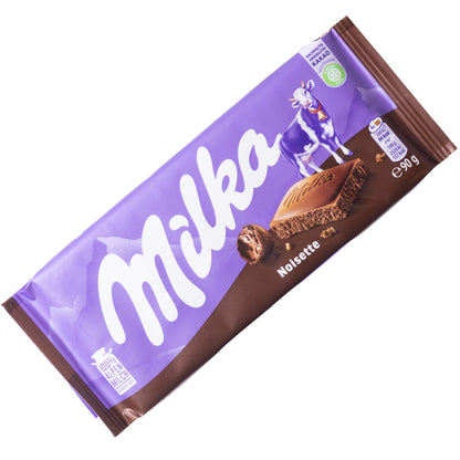 Milka Noisette hazelnut paste milk chocolate bar, 3.17 oz, front wrapper in purple with hazelnut shown