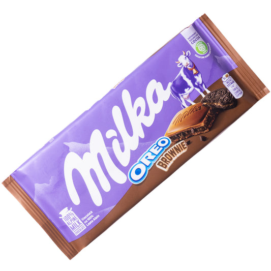 Milka Oreo Brownie milk chocolate bar, 3.5 oz — purple-and-brown wrapper with Oreo Brownie label, cookie piece, and chocolate square shown.
