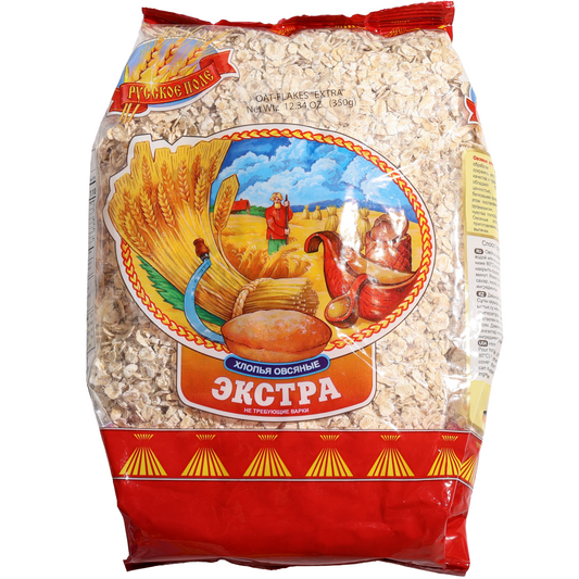 Russian Field Extra Oat Flakes, 12.34 oz (350 g) — quick-cooking oat flakes ideal for hot cereals, overnight oats, baking, and wholesome breakfast recipes. Made from rolled oats and packaged in a clear bag showcasing the flakes with traditional Russian Field farm-themed branding.
