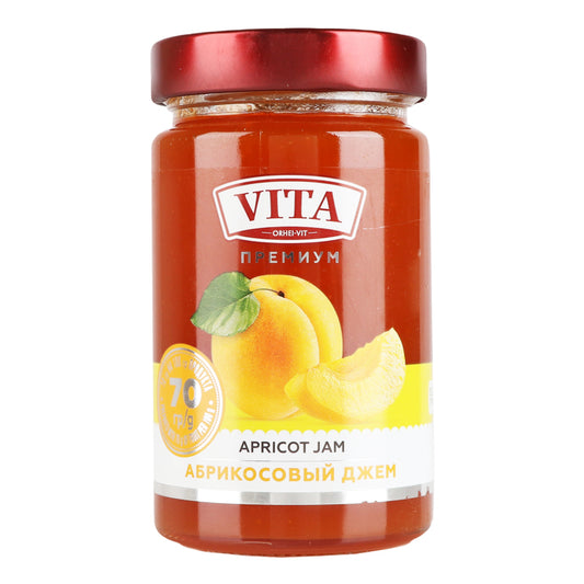A jar of Vita Premium Apricot Jam with a label showing the brand name, apricot pieces, and the text 'APRICOT JAM' in English and Russian.
